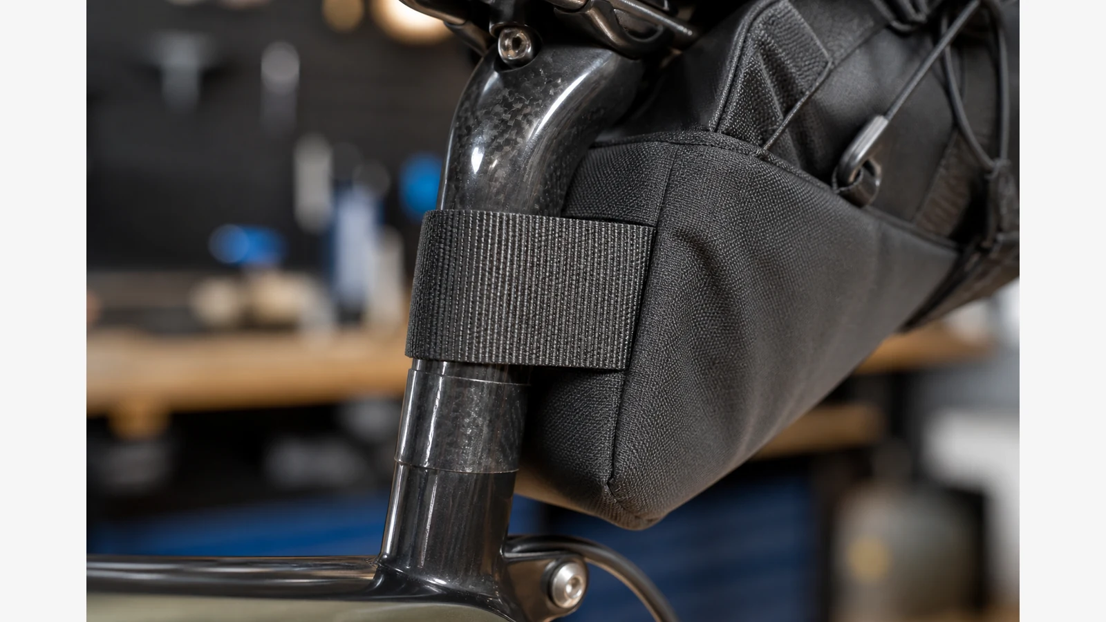 Clear protective tape on a carbon seatpost under a bike seat pack strap